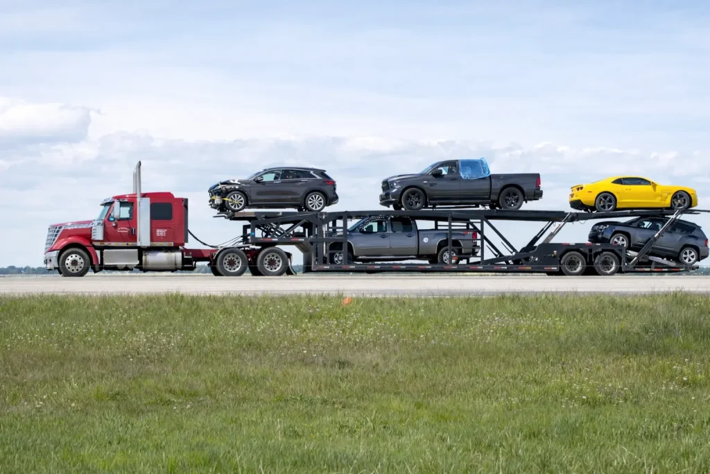 Side View of a Red Truck Delivering Cars